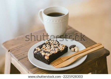 Chocolate brownie with hazelnuts, nut dessert with dark chocolate and hazelnuts, delicious tart cake with chocolate and roasted hazelnuts on top, A healthy dessert, Selective focus.