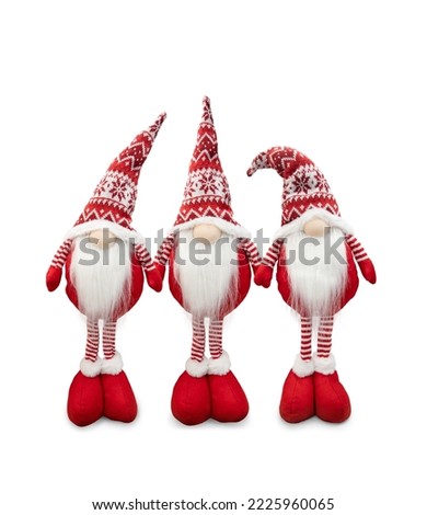 Three Scandinavian gnome in red hats isolated on white. Decorative Christmas toys on white background.