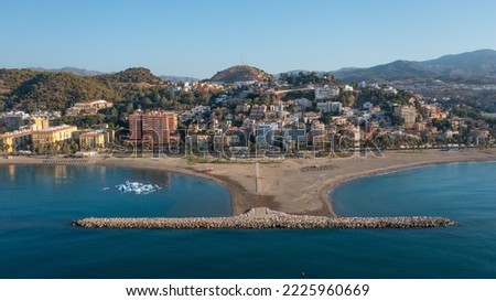 Aerial photo from drone to Malagueta ,La Caleta beaches and Malaga city skyline on a beautiful summer at sunrise. Malaga, Andalusia, Costa del Sol of Mediterranean, Europe 

