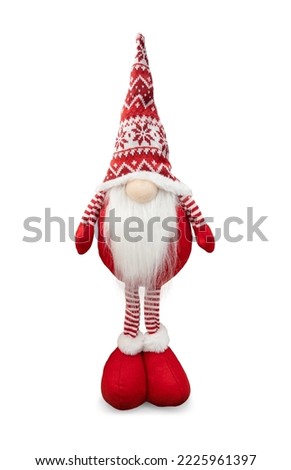 Gnome a Christmas elf in red hat standing isolated on white background.