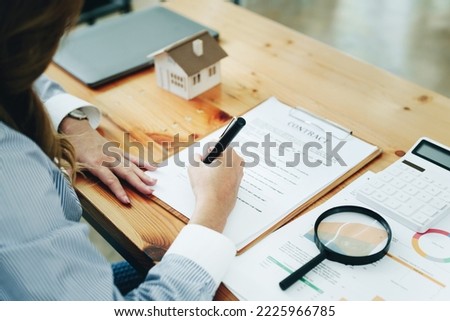Guarantee, Mortgage, agreement, contract, Signing, Male client holding pen to reading agreement document to sign land loan with real estate agent or bank officer