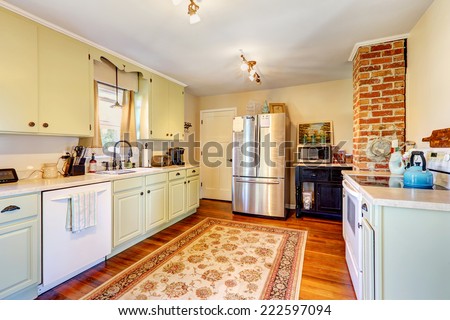 Kitchen room interior in old house with brick and light mint storage combination Royalty-Free Stock Photo #222597094