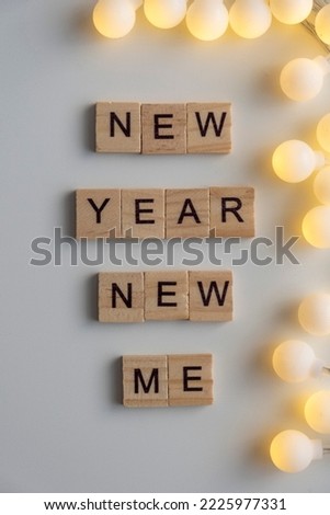 New year new you sign with garland white background. Top view