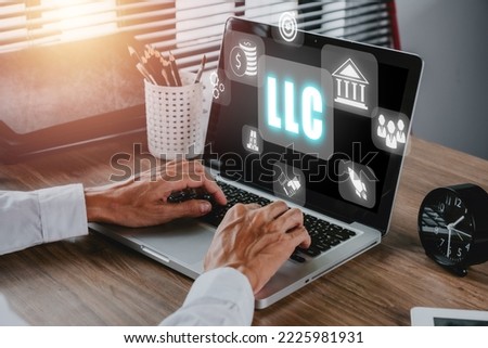 Limited Liability Company (LLC) Business Concept, Person hand using computer and hand touching limited liability company icon on Vr screen. Royalty-Free Stock Photo #2225981931