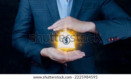 Businessman offers wooden house between his hands.monetary growth, interest rate increase, inflation concept,Interest rate financial and mortgage rates concept,Business home idea