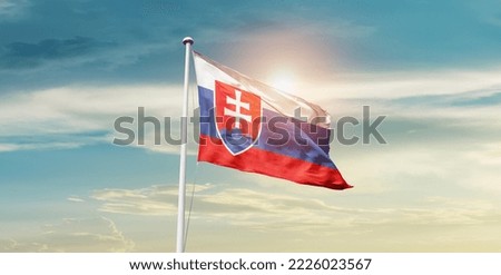 Slovakia national flag waving in beautiful clouds.