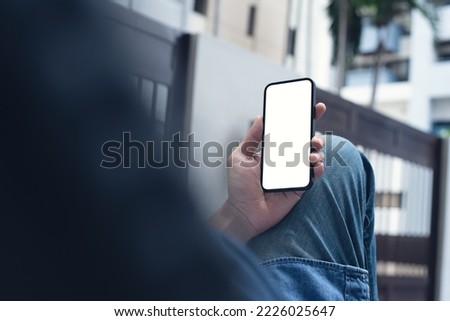 Mockup image of mobile phone for advertising. Mock up image of man hand holding and using smartphone with blank screen for mobile app design, people lifestyle