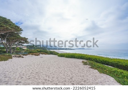 Carmel beach,  a long, wide, white sand beach. Carmel Beach is one of the most iconic spots on California's Central Coast Royalty-Free Stock Photo #2226052415
