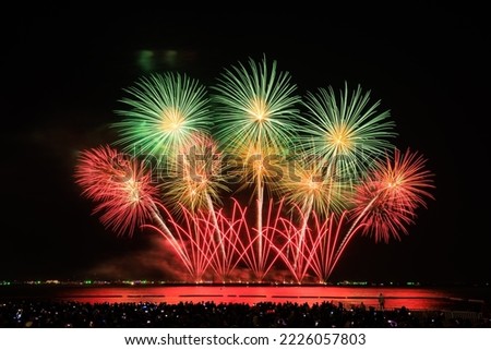 PATTAYA, CHONBURI, THAILAND, Beautiful colorful fireworks night scene shot at Pattaya International Fireworks Festival and silhouette Group of people tourist shoot and record pictures  firework show  Royalty-Free Stock Photo #2226057803