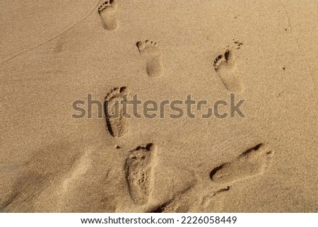 Child footprints on sandy beach