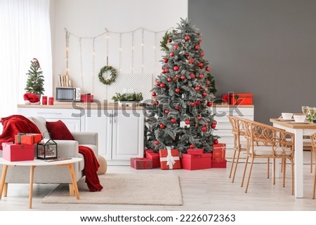 Interior of kitchen with Christmas trees and dining table