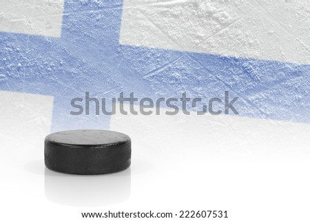 Hockey puck and the image of the Finnish flag. Concept