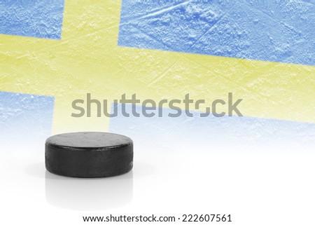 Hockey puck and the image of the Swedish flag. Concept