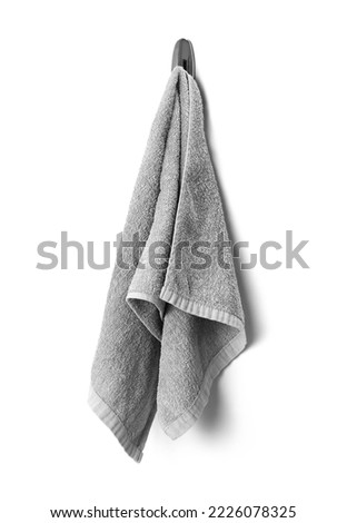 Grey towel hanging on a hook closeup isolated on a white background. Royalty-Free Stock Photo #2226078325