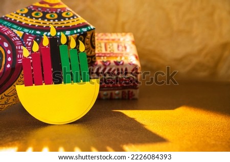 Happy Kwanzaa background with gifts in boxes wrapped in hand-painted paper
