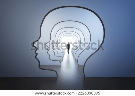 Mind labyrinth and business success psychology concept with back view walking businessman to the light spot in corridor with walls in form of human head Royalty-Free Stock Photo #2226098395