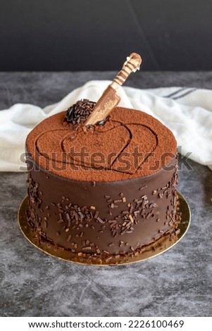Chocolate birthday cake on dark background. close up