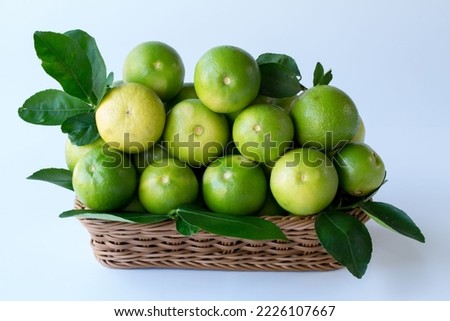 Fresh green lemons, in basket , Fresh green lemons at market and shop for sell.
