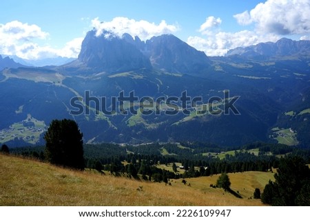 Majestic panoramic mountain view in the dolomites: Distinctive Sassolungo mountain group at gardena valley in south tyrol. View from Piz Pic mountain to sella group and Alp di Siusi	