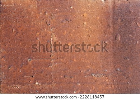 A Textured stucco full frame image in glossy terracotta colour. Real and authentic picture texture, background, pattern, poster, collage, gift wrap, wallpaper.