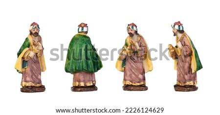 One of the three wise men in different positions. Ceramic figures isolated on white background 