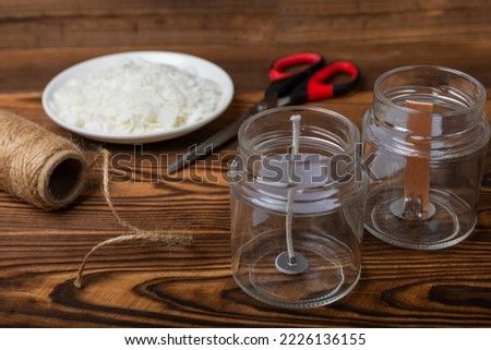 Ecological and vegan handmade soy wax candles with wooden wick. Transparent container, essential oil, soy wax, matches and dried flowers. MOCKUP, space for text. Handmade craft candles. Royalty-Free Stock Photo #2226136155