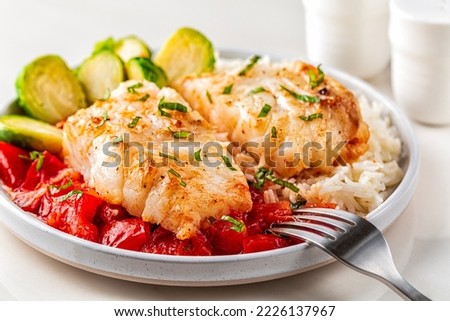 Baked cod fish, with tomato, brussel sprouts and boiled rice. Balanced food concept. Close-up.
