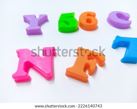 Colorful Magnet alphabet toys on white background.