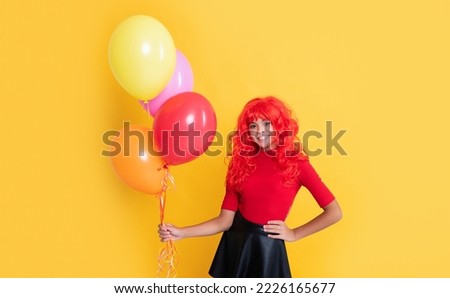 happy child with party balloon on yellow background
