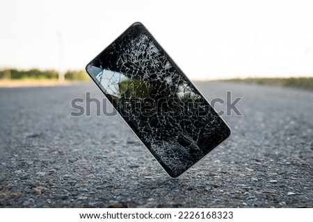 Mobile phone falling and crashes on asphalt, broken smartphone flying down to ground. Smashed, destroyed, damaged cellphone. Accident with gadget concept. Device need repairing. Crash test Royalty-Free Stock Photo #2226168323