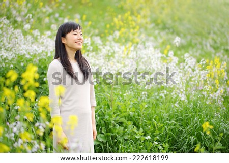 Beautiful young woman on the green. Portrait of asian woman.