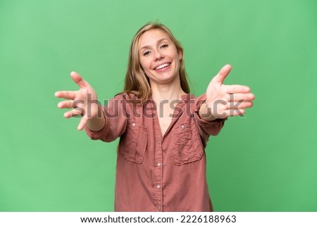 Young blonde woman over isolated background presenting and inviting to come with hand