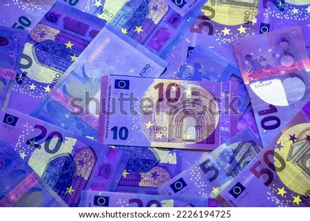 Euro currency in UV light protection. Euro in UV light to check the authenticity of the money.