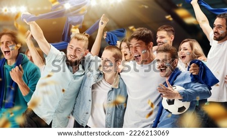 Young emotive football fans from Argentina cheering national soccer team with blue scarfs at crowded stadium. Concept of sport, support, team event, competition. Collage, banner, poster Royalty-Free Stock Photo #2226213069