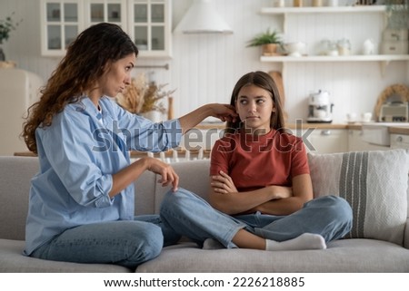 Young woman loving supportive mother trying to help depressed teen daughter, coping with teenage behavior. Mom talking positively to upset teenager, cheering up kid. Parent-teen relationships Royalty-Free Stock Photo #2226218885