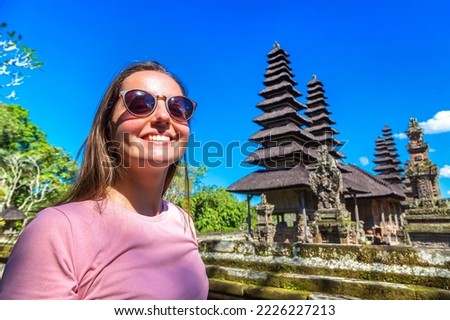 Woman traveler at  Taman Ayun Temple on Bali, Indonesia in a sunny day