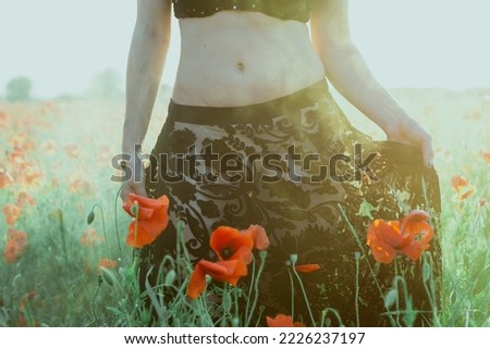 Close up lady in poppy field concept photo. Beautiful lady. Front view photography with sunlit meadow on background. High quality picture for wallpaper, travel blog, magazine, article