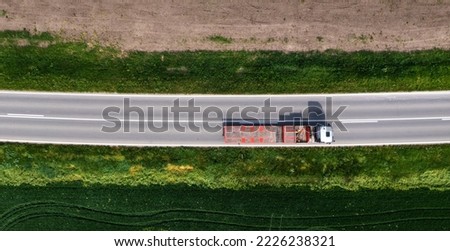 Aerial shot of truck with semi-trailer for container transport from drone pov, directly above Royalty-Free Stock Photo #2226238321