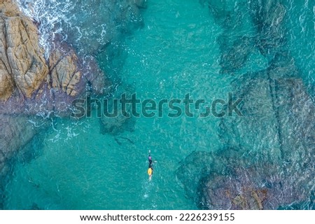 Aerial top view from drone of a swimmer in open water with wetsuit and buoy Royalty-Free Stock Photo #2226239155