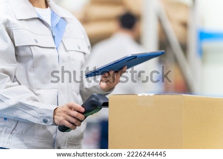 Warehouse management system with barcode reader and tablet PC. Inventory control. Royalty-Free Stock Photo #2226244445