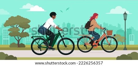Couple riding bicycles at the city park, sport and leisure concept
