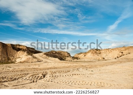 sand quarry, in the photo, a quarry for the extraction of sand against a blue sky.