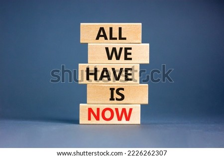 All we have is now symbol. Concept words All we have is now on wooden blocks. Beautiful grey table grey background. Business, motivational all we have is now concept. Copy space.