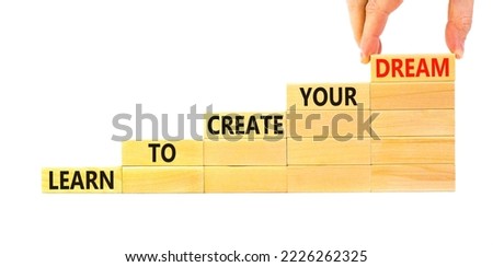 Create your dream symbol. Concept words Learn to create your dream on wooden blocks. Businessman hand. Beautiful white table white background. Business learn to create your dream concept. Copy space