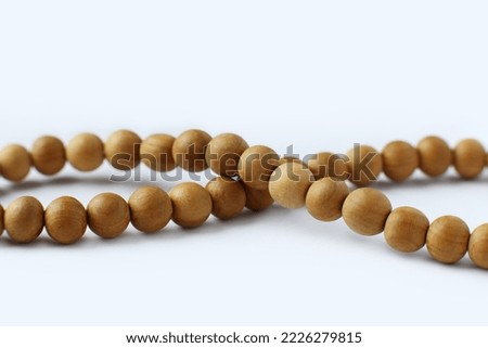 Rosary or wooden prayer beads isolated on white Royalty-Free Stock Photo #2226279815