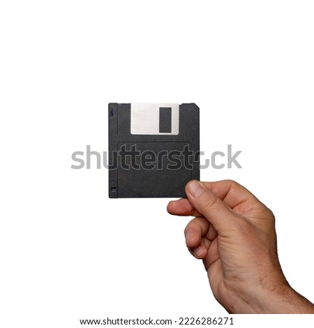 old floppy disk for data storage on hand on a transparent background