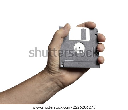 old floppy disk for data storage on hand on a transparent background