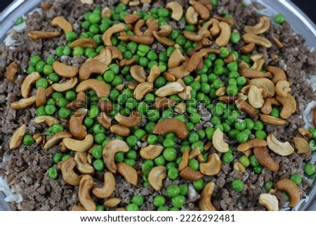 Rice and Peas Dish Topping of Minced Meat and Cashew Nuts  Stock Photos