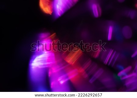 Blurred Light painting one exposure in camera. light glares with a spectral gradient on a dark background. Multicolored abstract colorful line. Unusual light effect. Royalty-Free Stock Photo #2226292657