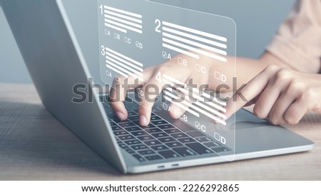 Virtual test or questionnaire show on screen and answer check mark to measure grades. Education futuristic technology. Students taking online exams by laptop and Lifelong learning concept. Royalty-Free Stock Photo #2226292865